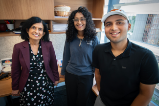 Three People standing in an office and looking at the camera